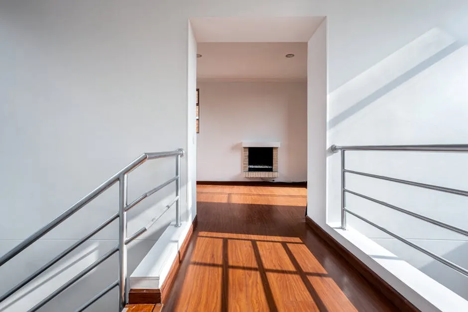 Bright apartment hallway with railings and wooden floor — Airport Residential